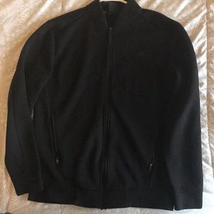 This is a rich black athletic jacket by Russell. It is in great condition.